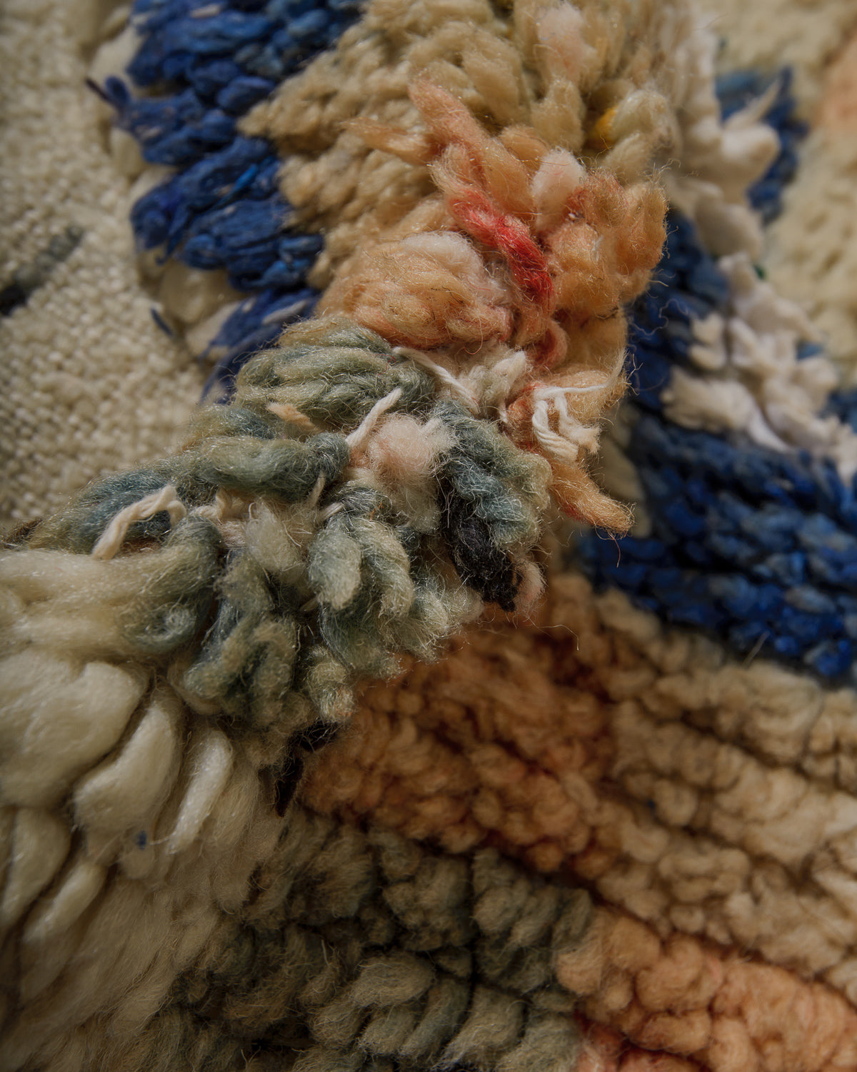 Detail of vintage wool Berberlin rug repaired with white cotton.